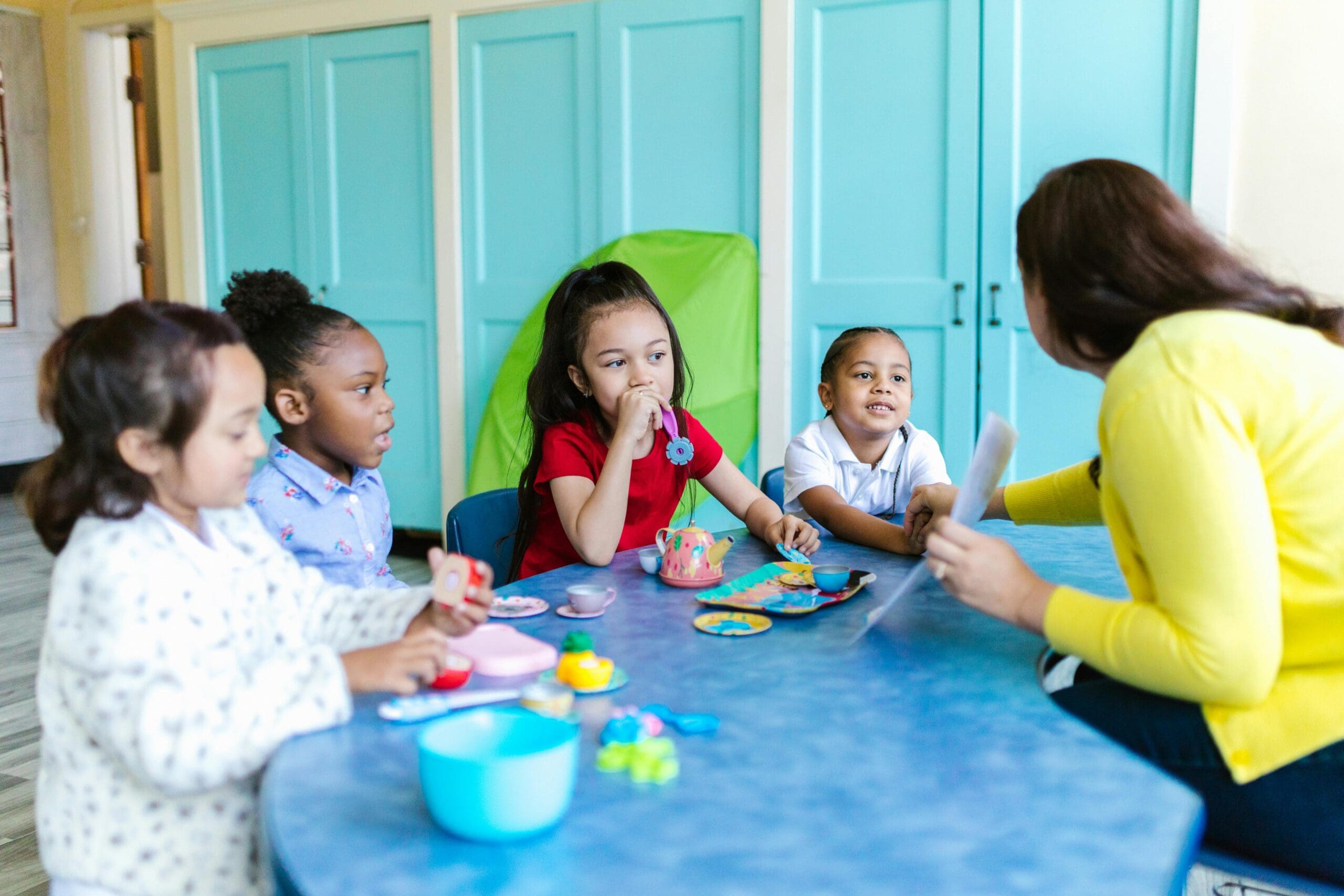 children and a teacher in the class room